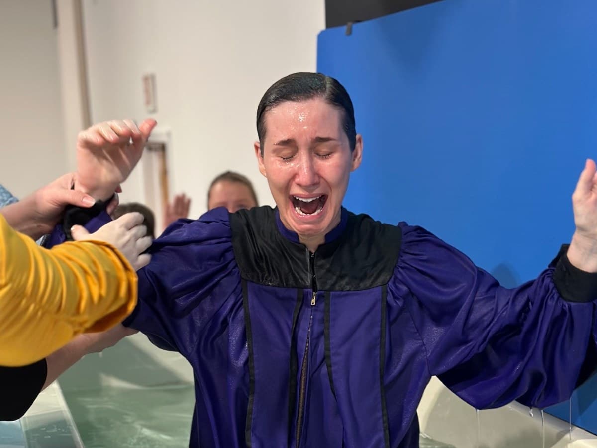 A lady being baptized at New Life Apostolic